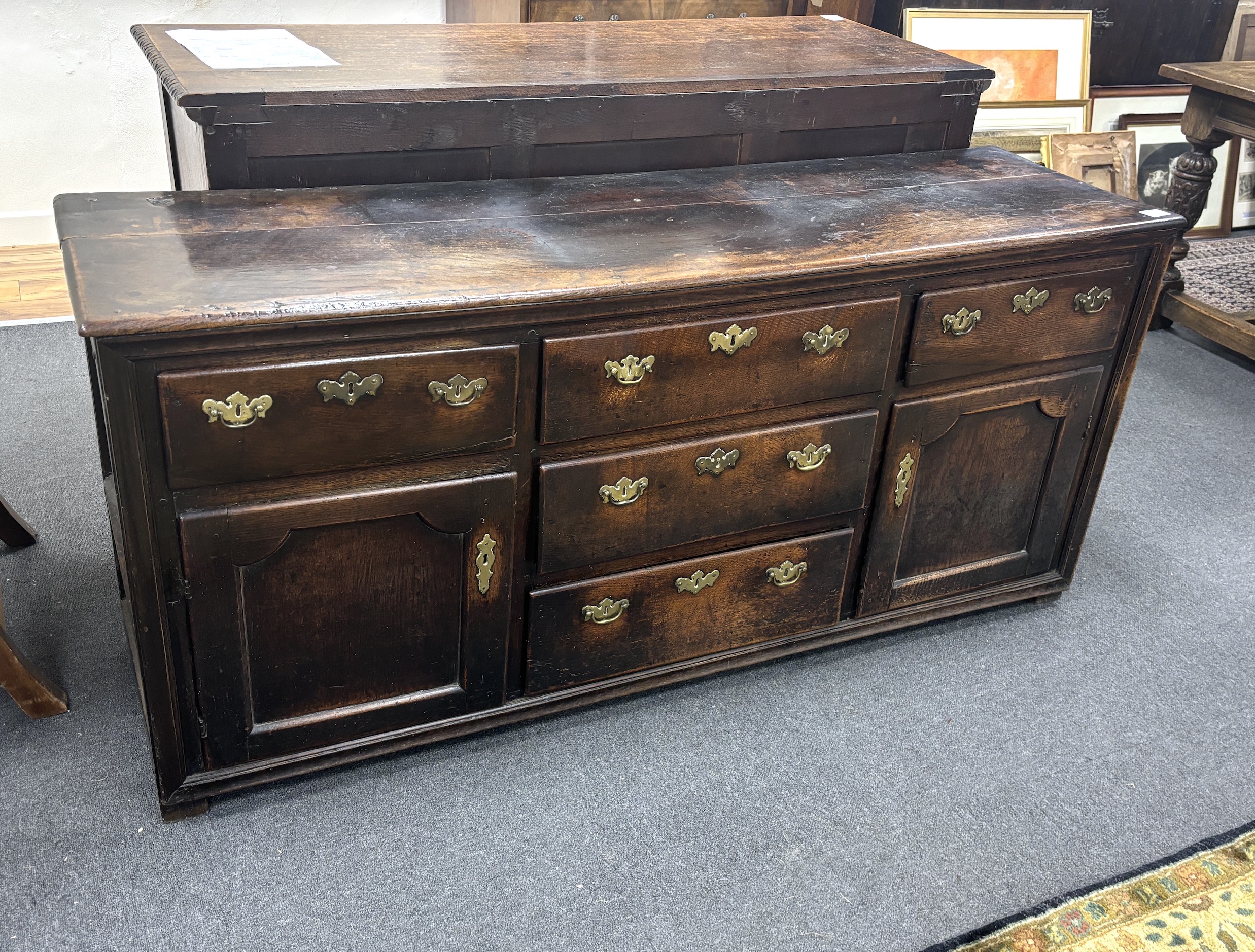 A mid 18th century oak low dresser, fitted five drawers, flanked by panelled doors, width 174cm, depth 48cm, height 79cm